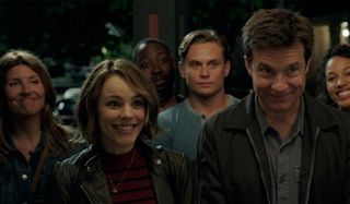 Game Night Rachel McAdams and Jason Bateman standing outside with their group of friends, smiling aw