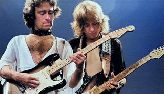 View of, from left, English Rock & Blues musicians Paul Rodgers (left) and Mick Ralphs, both of the band Bad Company, plays guitars as they perform, during the 'Burnin' Sky' tour, onstage at Madison Square Garden, New York, New York, July 31, 1977