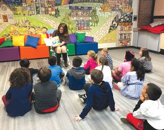 Nancy Battaglia reads a picture book on online safety to kindergarten students at Jane Stenson Elementary School.