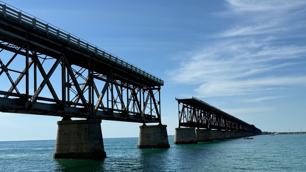 a partly broken bridge over a vast expanse of water.