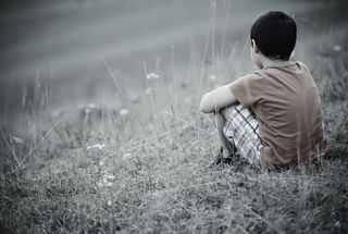 Boy sitting alone - abuse, advocacy 