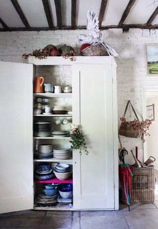 Freestanding kitchen cupboard in farmhouse kitchen decorated for Christmas