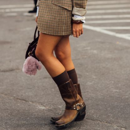 woman wearing brown moto boots