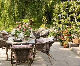 outdoor dining with geraniums on patio
