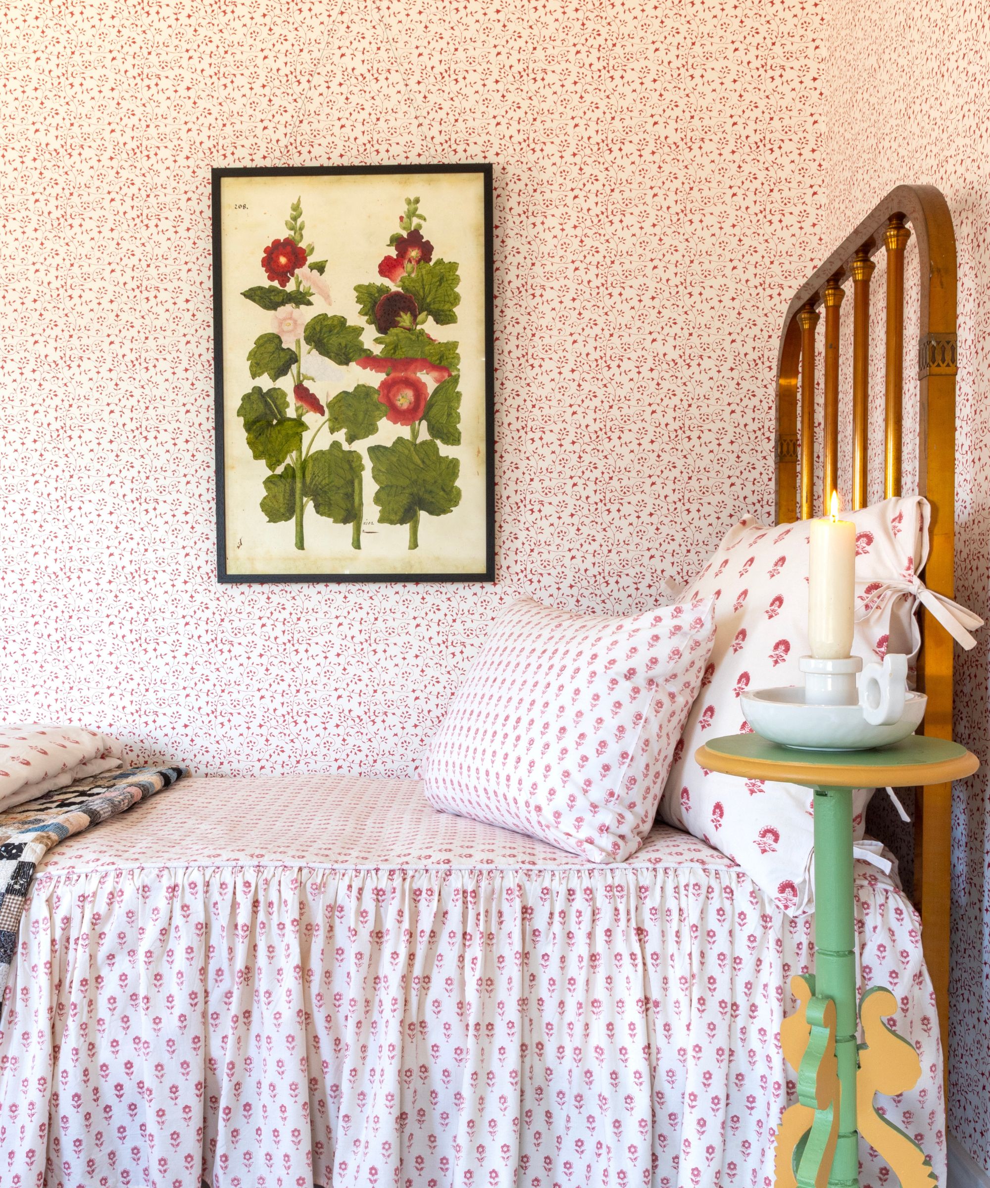 bedroom with pink small-scale floral wallpaper and bedding