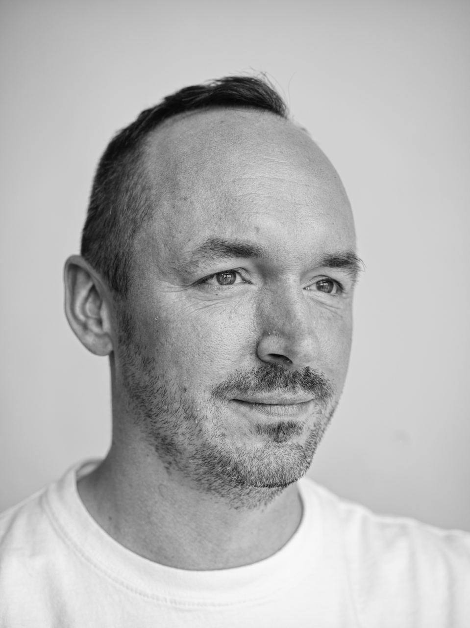 man in black and white photo with white t-shirt