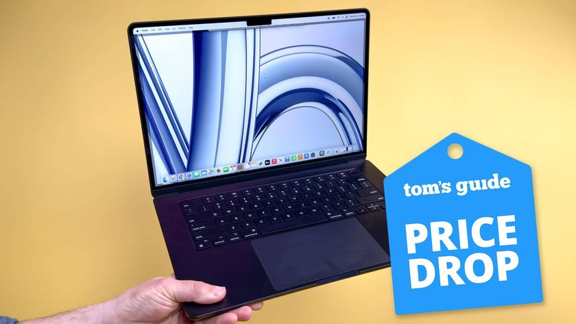 MacBook Air M3 13-inch held in hand with Tom&#039;s Guide Price Drop badge