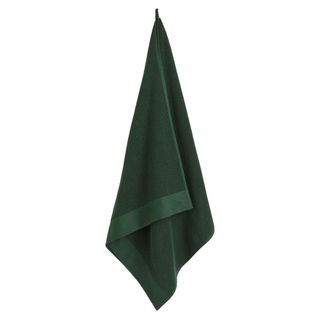 Green towel hanging on a hook