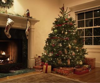 Christmas tree by fireplace