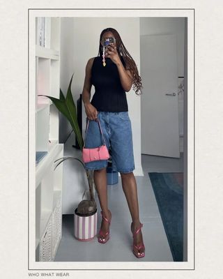 @the_oluwaseun wearing jorts with a pleated top and shoulder bag