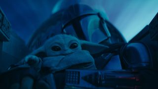 Din Djarin holds onto Grogu in his starfighter cockpit in The Mandalorian season 3, one of the best Disney Plus shows ever