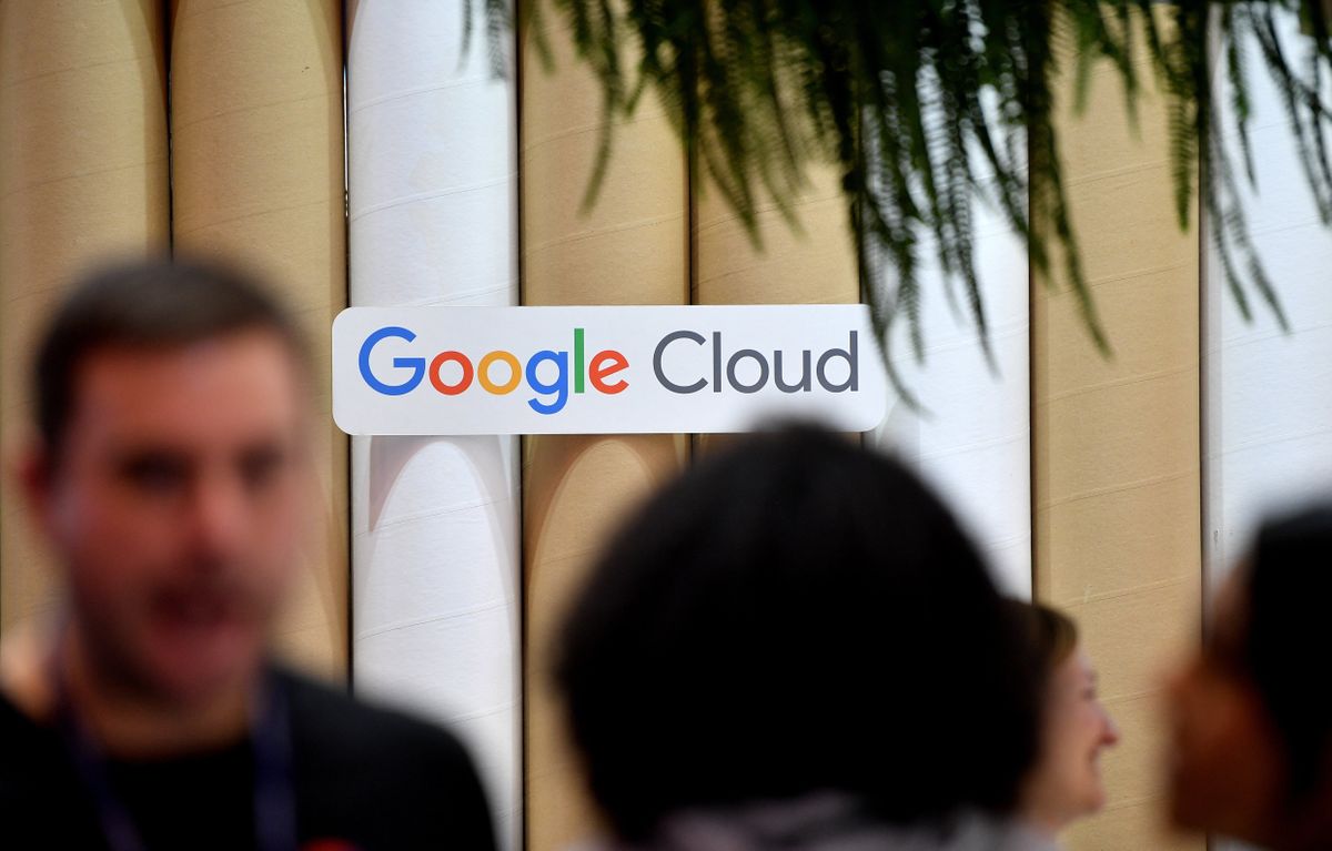 Google Cloud logo on a sign atatched to a bamboo-looking wall at Web Summit 2022