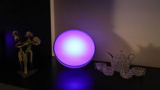 Philips Hue Go 2 with purple light on a shelf