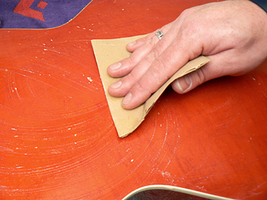 Sanding the guitar's rear