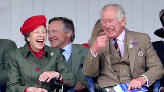 Princess Anne laughing with brother King Charles
