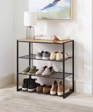 A black shoe rack with shoes on it