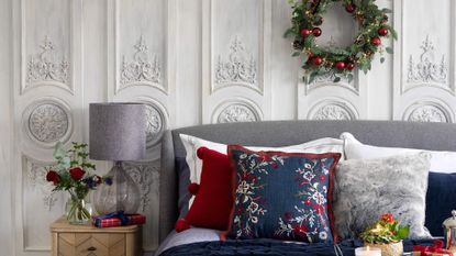Bed dressed with Christmas bedding and wreath