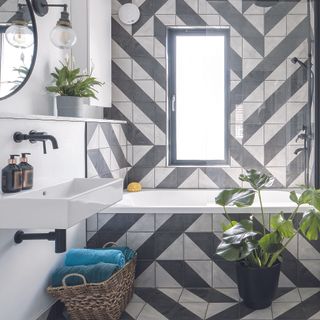 Black and white tiled bathroom with abstract pattern