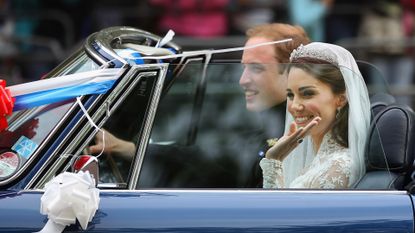 Prince William, Duke of Cambridge and Catherine, Duchess of Cambridge drive from Buckingham Palace in a decorated sports car on April 29, 2011 in London, England. The marriage of the second in line to the British throne was led by the Archbishop of Canterbury and was attended by 1900 guests, including foreign Royal family members and heads of state. Thousands of well-wishers from around the world have also flocked to London to witness the spectacle and pageantry of the Royal Wedding.
