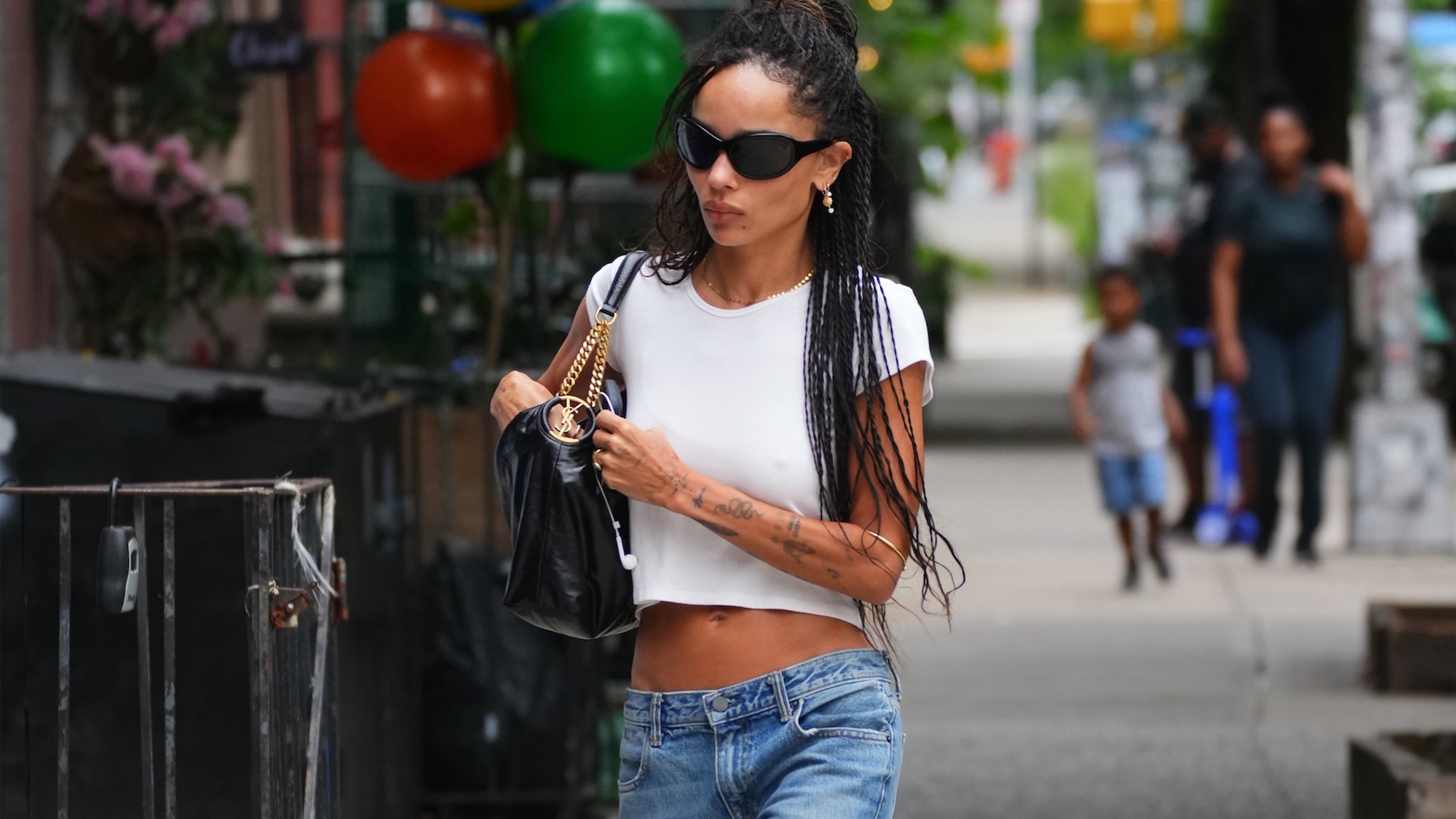 zoe kravitz wearing jeans and a white t shirt
