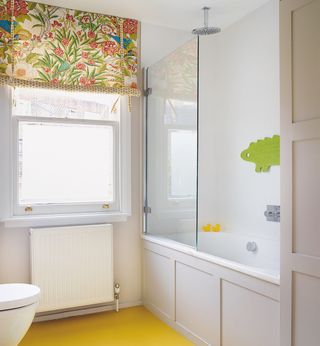 bathroom with white wall bathtub white window and yellow floor