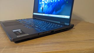 The Lenovo Legion 5i (2022) gaming laptop on a wooden desk.