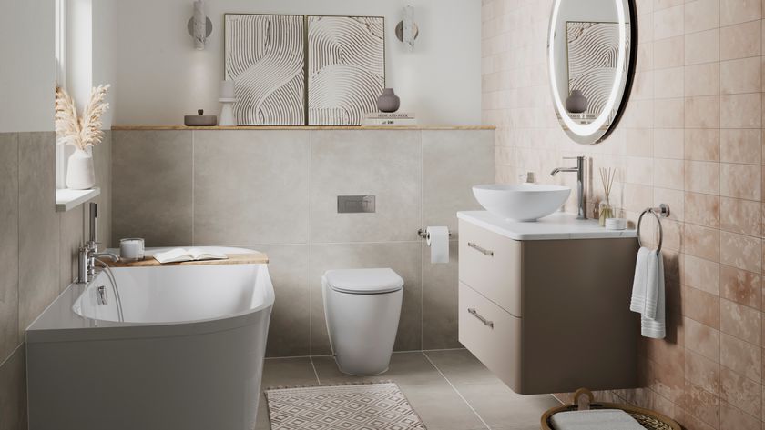 back to wall freestanding style bath in small bathroom with wall hung vanity and toilet, pale pink and cream tiling