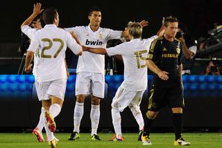 Cristiano Ronaldo celebrates with his Real Madrid team-mates after scoring against LA Galaxy in 2011.