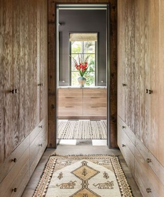 Dressing room with wooden closets either side of an entryway