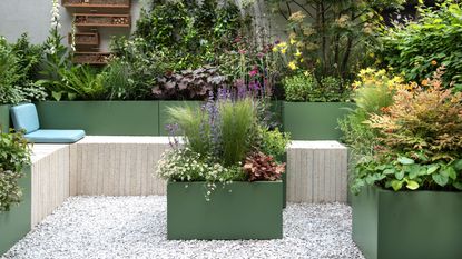 Colourful pots and planters with perennials planting, on the MS Amlin Peace of Mind Garden, designed by Hamzah-Adam Desai, at the RHS Chelsea Flowers Show 2025