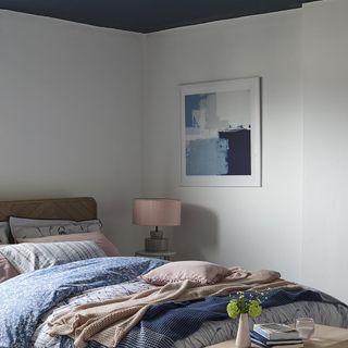 bedroom with bed and bedside stool with lamp