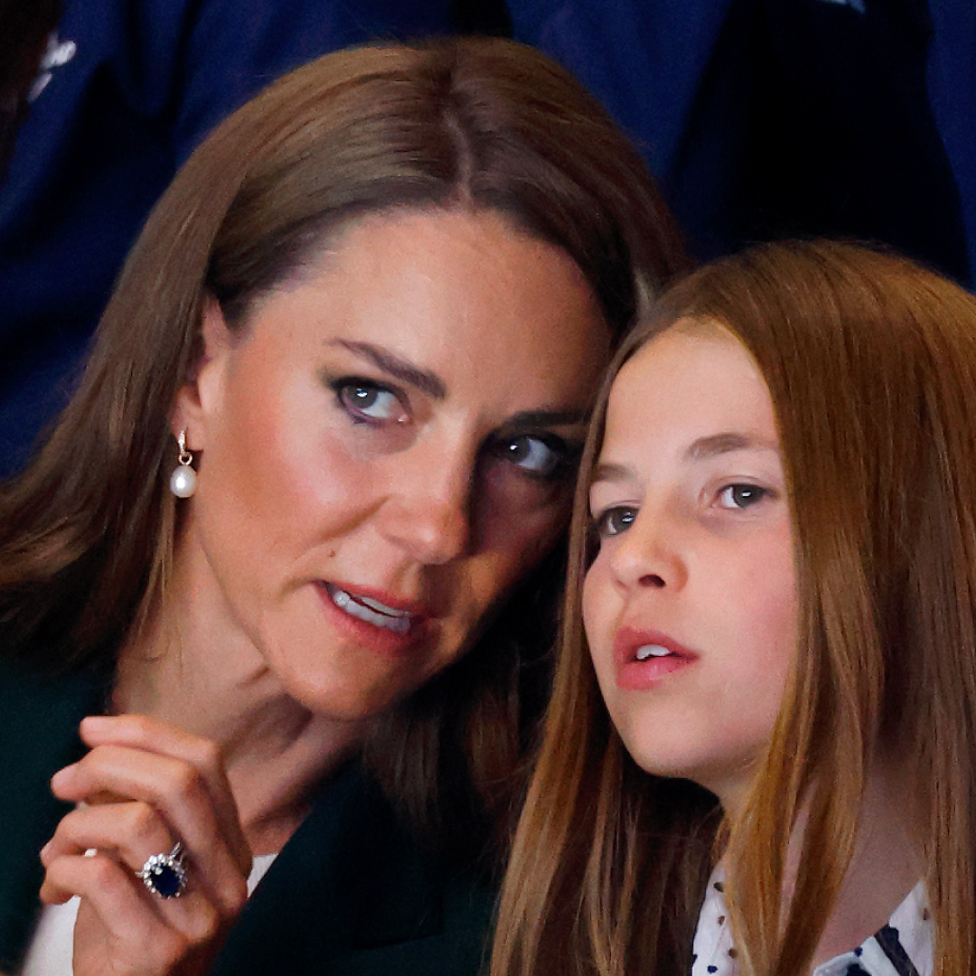 Princess Kate and Princess Charlotte with their heads together at the Commonwealth Games