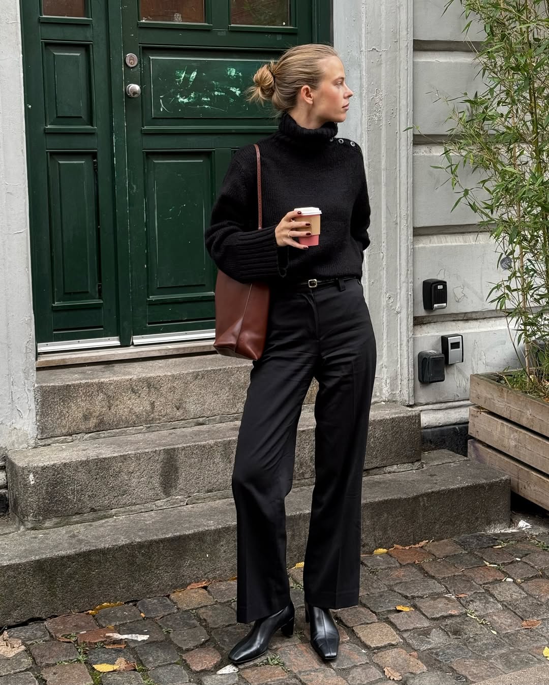 An image of influencer @claradyrhauge wearing shoes with satin trousers.