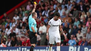 West Ham midfielder Lucas Paqueta is shown a yellow card in a Premier League game at Bournemouth in August 2023.