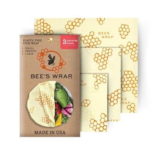 A brown paper pack on top of three squares of yellow beeswax wraps