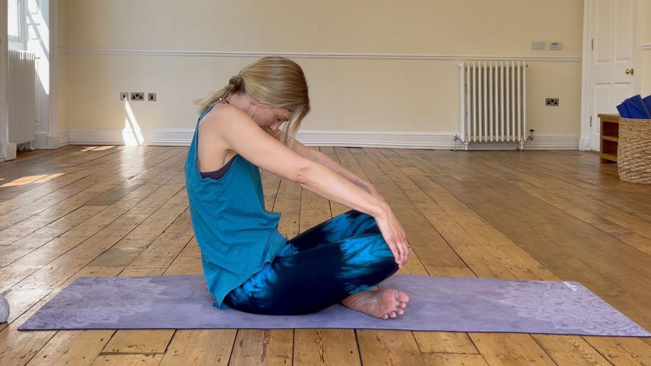 Michelle Maslin-Taylor, yoga teacher, demonstrates seated cow pose