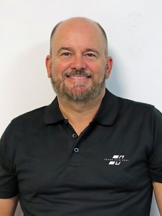 A smiling head shot of new DAS Audio VP of Sales, Pro Audio Michael Palmer.