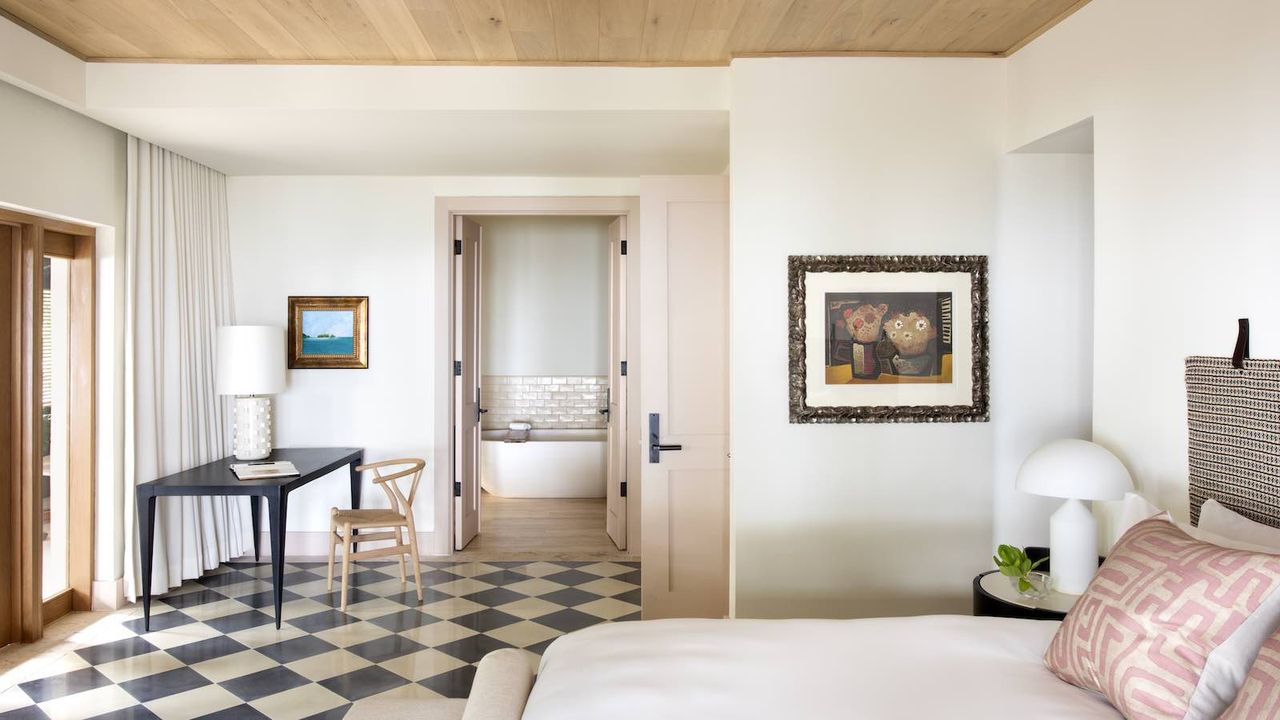 pink bedroom with wood ceiling and checked floors