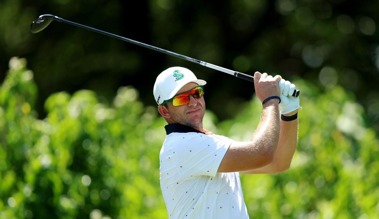 Dean Burmester watches his tee shot after striking a hybrid