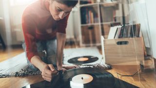 Person with turntable on floor