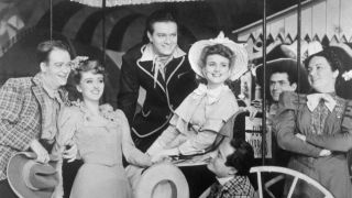 (Original Caption) This is the original company in the 1943 production of Oklahoma. From left are Lee Dixon, (Will Parker); Celeste Holm, (Ado Annie); Alfred Drake, (Curly); Joan Roberts, (Laurey); Joseph Buloff, (Ali Hakim); and Betty Garde, (Aunt Eller).