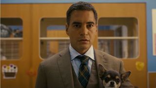 Ramón Rodríguez as Will Trent holding a dog in Will Trent