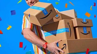 Man holding Prime Day boxes against blue background