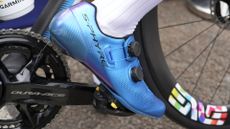 A rider clipping into his pedals