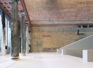 The entry hall of the Neue Museum in Berlin juxtaposes new and old materials