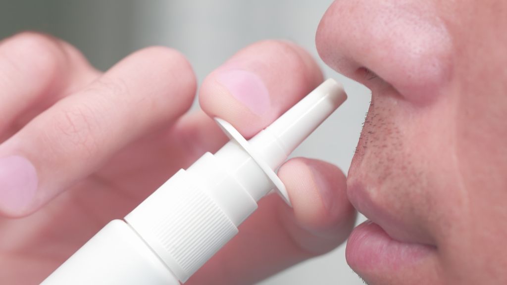 man using nasal spray