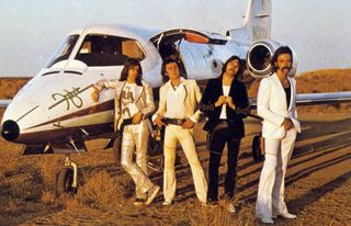 Foghat standing by a Foghat-branded private jet