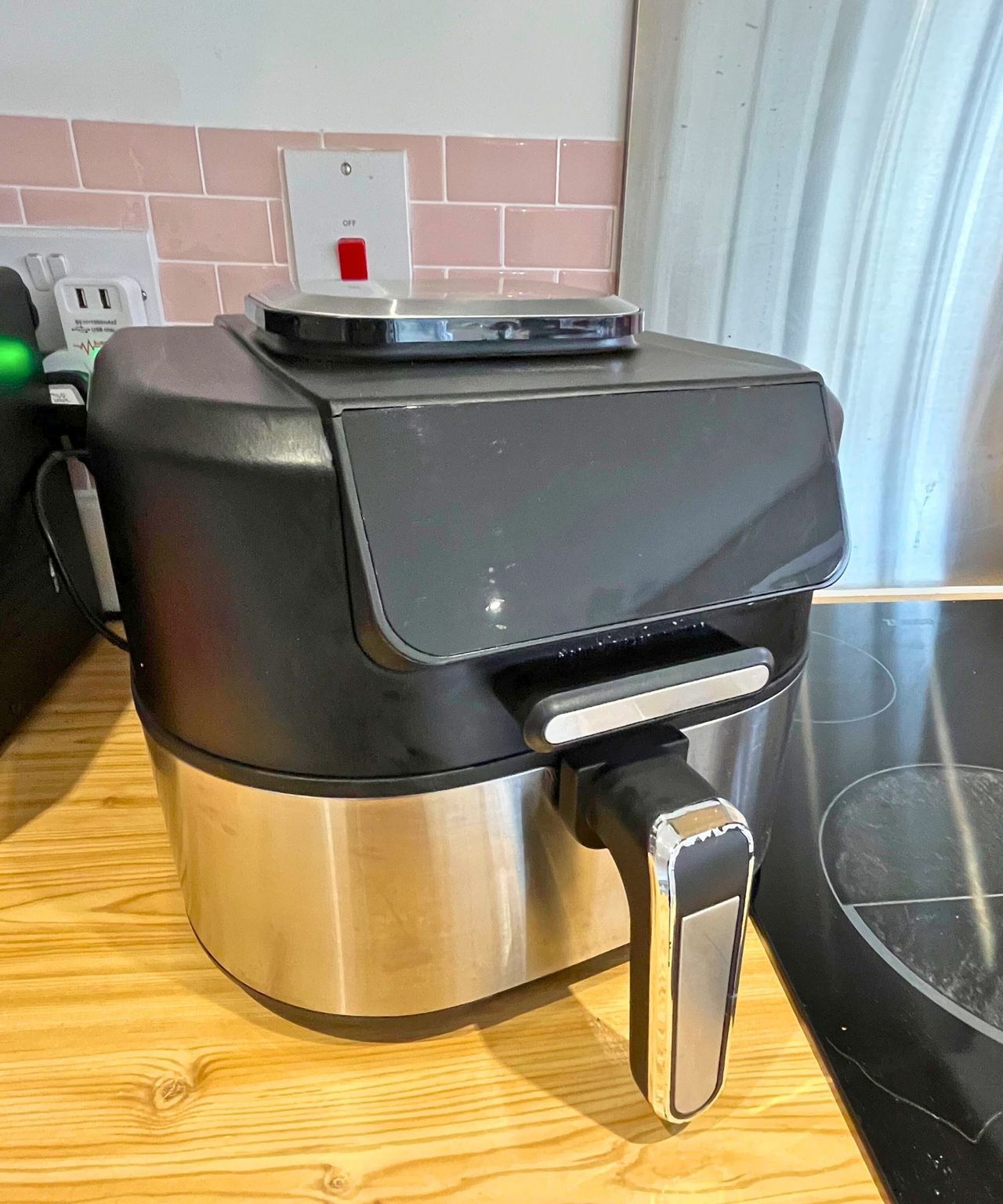 After image of black air fryer with stainless steel lower half that has no grime or streaks
