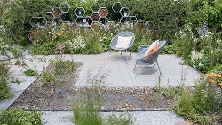 pollinator friendly garden design with pond, insect hotels, white gravel and drought tolerant planting