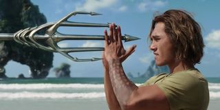 Young Arthur Curry catching trident in Aquaman